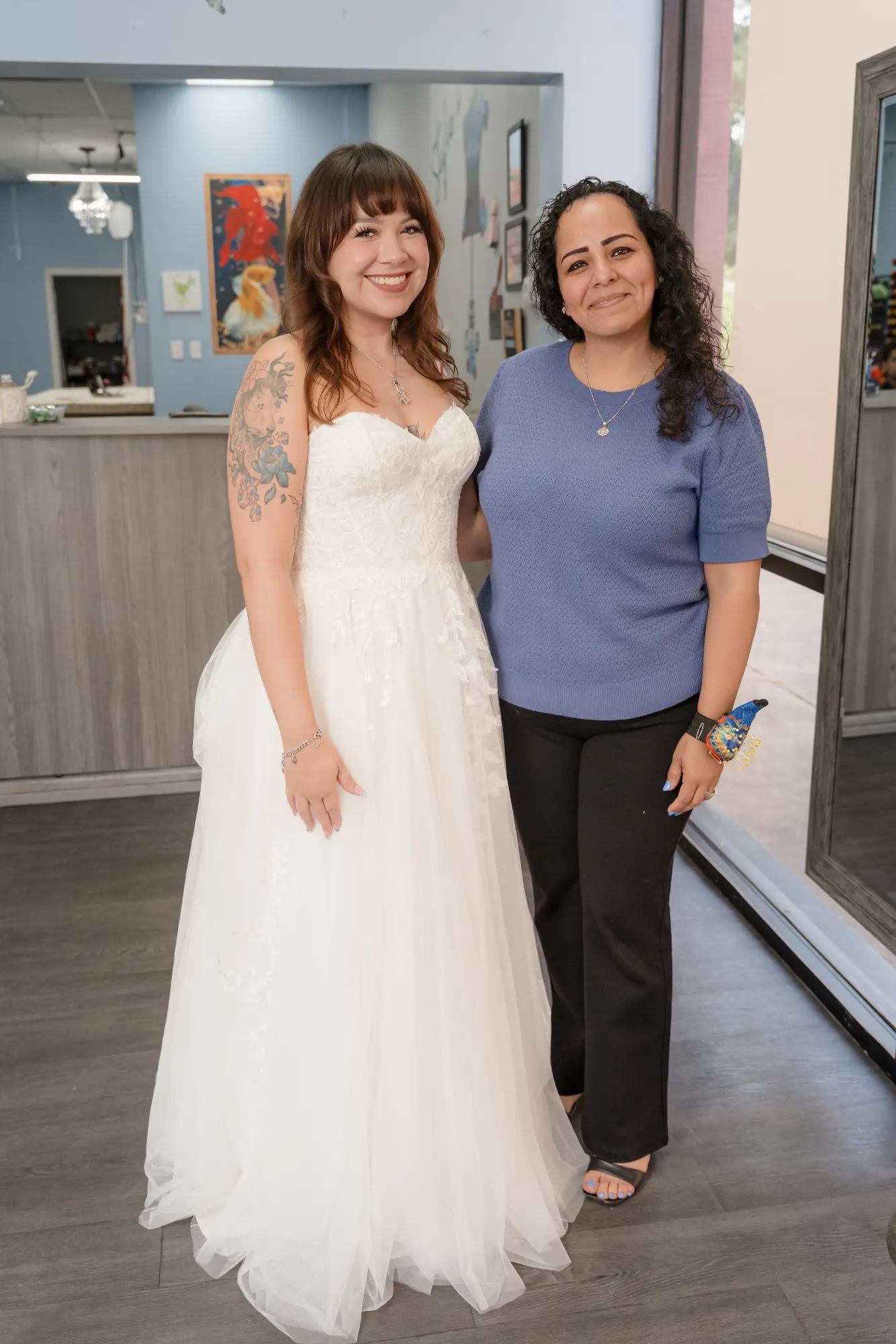 Expert tailor posing with a happy client