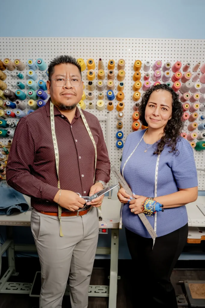 Professional tailors Edin and Martha posing in their atelier