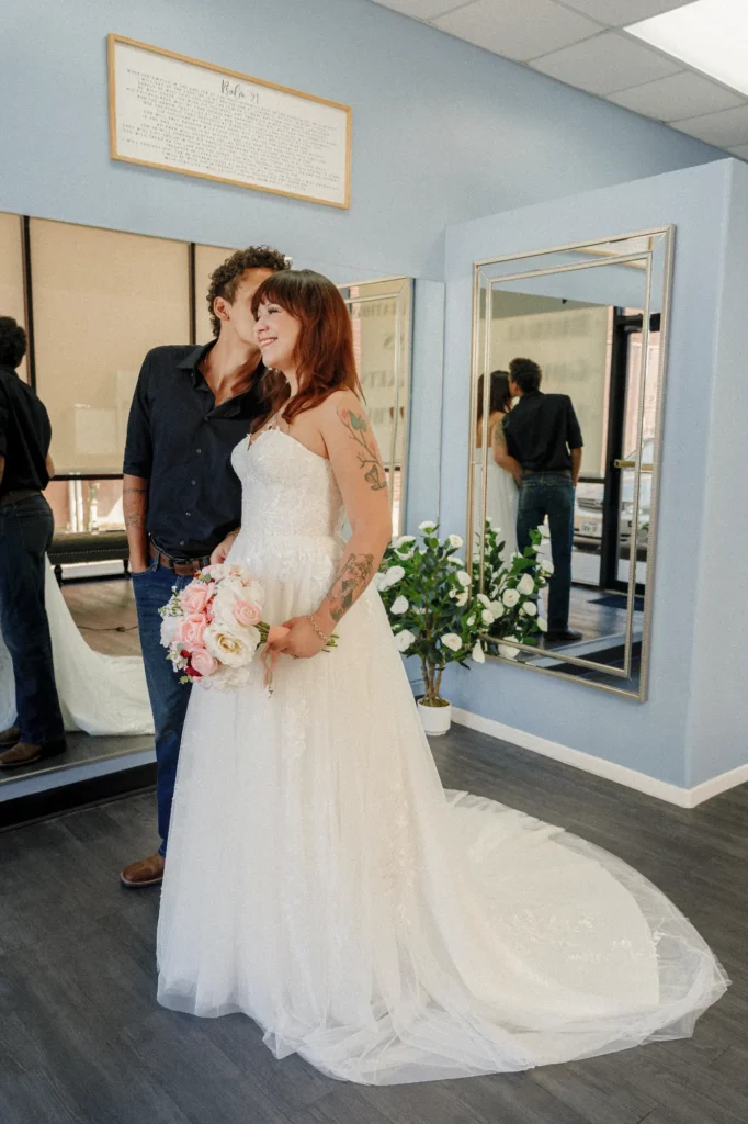 Happy future bride and groom posing in front of mirrors